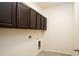 Laundry room featuring upper cabinets, tile floor, and washer and dryer hookups at 4004 Prima Lago Cir, Lakeland, FL 33810