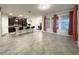 Open-concept living room, dining, and kitchen area featuring barstool seating and large windows at 4004 Prima Lago Cir, Lakeland, FL 33810