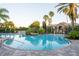 Beautiful community pool with inviting clear water and tropical landscaping at 4004 Prima Lago Cir, Lakeland, FL 33810