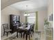 Formal dining room boasts elegant décor, complemented by a stylish chandelier and beautiful rug at 4009 Bedford Ave, Winter Haven, FL 33884