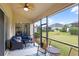 Screened lanai featuring comfortable seating and view of the backyard at 4009 Bedford Ave, Winter Haven, FL 33884