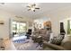 Open-concept living room with neutral colors, comfortable seating, and access to the screened patio at 4009 Bedford Ave, Winter Haven, FL 33884