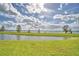 Tranquil backyard with view of the lake and lush green lawn at 404 Laurel Cove Way # 404, Winter Haven, FL 33884