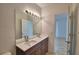 Stylish bathroom with a double sink vanity, modern lighting, and a walk-in shower, creating a serene retreat at 404 Laurel Cove Way # 404, Winter Haven, FL 33884
