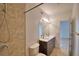 Bathroom with a large tiled walk-in shower, modern fixtures, and a double sink vanity with a large mirror at 404 Laurel Cove Way # 404, Winter Haven, FL 33884