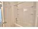Bathroom showing a tub and shower combination with white surround and a door to the left at 404 Laurel Cove Way # 404, Winter Haven, FL 33884