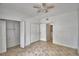 Bedroom featuring tan tile floor, ceiling fan, and closet with double doors at 404 Laurel Cove Way # 404, Winter Haven, FL 33884