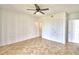 Spacious bedroom featuring tile floors, ceiling fan, and multiple closets for ample storage at 404 Laurel Cove Way # 404, Winter Haven, FL 33884