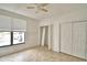 Bedroom with tan tile floor, ceiling fan, and window with blinds at 404 Laurel Cove Way # 404, Winter Haven, FL 33884