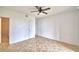 Bright bedroom boasts tile floors, a ceiling fan, and direct access to an en-suite bathroom at 404 Laurel Cove Way # 404, Winter Haven, FL 33884