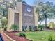 Community entrance with a stone sign, well-maintained landscaping, and a manicured lawn at 404 Laurel Cove Way # 404, Winter Haven, FL 33884