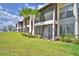 Exterior view of condo with a screened patio, palm trees and lush landscaping at 404 Laurel Cove Way # 404, Winter Haven, FL 33884