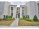 Inviting condo exterior with well-maintained landscaping and a charming walkway to the entrance at 404 Laurel Cove Way # 404, Winter Haven, FL 33884