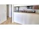 Functional kitchen area with a breakfast bar overlooking stainless steel appliances and tiled floors at 404 Laurel Cove Way # 404, Winter Haven, FL 33884