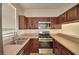 Well-equipped kitchen featuring stainless steel appliances, ample cabinetry, and a window at 404 Laurel Cove Way # 404, Winter Haven, FL 33884