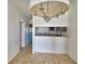 Open kitchen layout featuring tile floors, chandelier and a convenient breakfast bar at 404 Laurel Cove Way # 404, Winter Haven, FL 33884