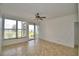 Bright and spacious living room with tiled floors, ceiling fan, and sliding glass doors offering scenic views at 404 Laurel Cove Way # 404, Winter Haven, FL 33884