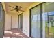Enclosed patio with a ceiling fan, sliding glass doors, and brick flooring at 404 Laurel Cove Way # 404, Winter Haven, FL 33884