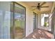 Enclosed patio featuring a ceiling fan, sliding glass doors, and brick flooring at 404 Laurel Cove Way # 404, Winter Haven, FL 33884
