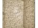 Close-up of a tiled walk-in shower featuring a shower head and built-in soap dish at 404 Laurel Cove Way # 404, Winter Haven, FL 33884