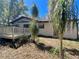 A serene backyard featuring a wooden deck, mature palm trees, and unique plantings for outdoor enjoyment at 407 Paradise Island Dr, Haines City, FL 33844