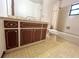 Bathroom featuring a decorative vanity, mirror, bathtub with shower and patterned floor at 407 Paradise Island Dr, Haines City, FL 33844