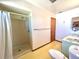 Functional bathroom with shower stall, single sink vanity, and vinyl flooring at 407 Paradise Island Dr, Haines City, FL 33844