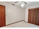 This bedroom features neutral walls and carpet, a ceiling fan, and a wood closet at 407 Paradise Island Dr, Haines City, FL 33844