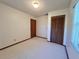 Bedroom with carpet, closet, window with blinds and door at 407 Paradise Island Dr, Haines City, FL 33844