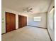 Bedroom with carpet, window with blinds, closet and door at 407 Paradise Island Dr, Haines City, FL 33844
