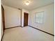 Bedroom with carpet, closet, window with blinds and door at 407 Paradise Island Dr, Haines City, FL 33844