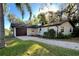 Single story home with a stone driveway and an attached garage at 407 Paradise Island Dr, Haines City, FL 33844