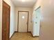 Neutral foyer with a white front door, and wood paneled closet at 407 Paradise Island Dr, Haines City, FL 33844