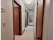 Hallway featuring neutral paint, doors leading to different rooms, and carpet flooring at 407 Paradise Island Dr, Haines City, FL 33844