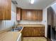 Kitchen featuring wooden cabinets and appliances with a window providing natural light at 407 Paradise Island Dr, Haines City, FL 33844