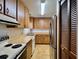 Functional kitchen featuring wood cabinetry, an electric range and stainless steel refrigerator at 407 Paradise Island Dr, Haines City, FL 33844