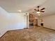 Open living room featuring a stone fireplace and a ceiling fan at 407 Paradise Island Dr, Haines City, FL 33844