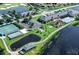 Stunning aerial view of the community clubhouse, pool, tennis courts, and golf course at 4168 Aberdeen Ln, Lake Wales, FL 33859
