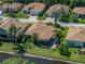 Aerial view of the home and surrounding community, showcasing the lakefront property and screened lanai at 4168 Aberdeen Ln, Lake Wales, FL 33859