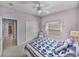 This bedroom features neutral carpet, a ceiling fan, and an ensuite bathroom and closet at 4168 Aberdeen Ln, Lake Wales, FL 33859