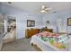 Comfortable bedroom with a dining area view, wooden furniture, and ceiling fan at 4168 Aberdeen Ln, Lake Wales, FL 33859