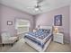 Cozy bedroom with a ceiling fan, neutral carpet, and a custom quilt at 4168 Aberdeen Ln, Lake Wales, FL 33859