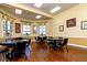 Bright dining area with tables and chairs, complemented by floral curtains and decorative wall art at 4168 Aberdeen Ln, Lake Wales, FL 33859