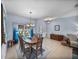 Bright dining room featuring a round wooden table, chandelier, and a large window at 4168 Aberdeen Ln, Lake Wales, FL 33859