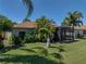 Rear of house showcases lawn and screened-in back patio area at 4168 Aberdeen Ln, Lake Wales, FL 33859
