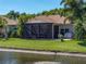Back exterior view of home featuring a screened-in lanai at 4168 Aberdeen Ln, Lake Wales, FL 33859