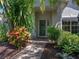 Inviting front entry featuring a green door, lush landscaping, and a brick pathway at 4168 Aberdeen Ln, Lake Wales, FL 33859