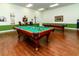 Game room with pool tables, cues, and comfortable seating, perfect for recreation and relaxation at 4168 Aberdeen Ln, Lake Wales, FL 33859