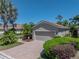 Charming one-story home with lush landscaping, green grass, and a two-car garage at 4168 Aberdeen Ln, Lake Wales, FL 33859