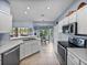 Kitchen featuring an open layout, stainless steel appliances, white cabinets and a breakfast nook at 4168 Aberdeen Ln, Lake Wales, FL 33859